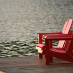 beach chairs by lake symbolizing retirement and collection of social security benefits