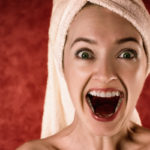 woman with surprised face indicating women may have to pay alimony or child support