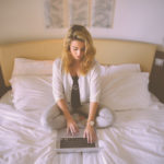 woman on laptop in bedroom symbolizing flirting online